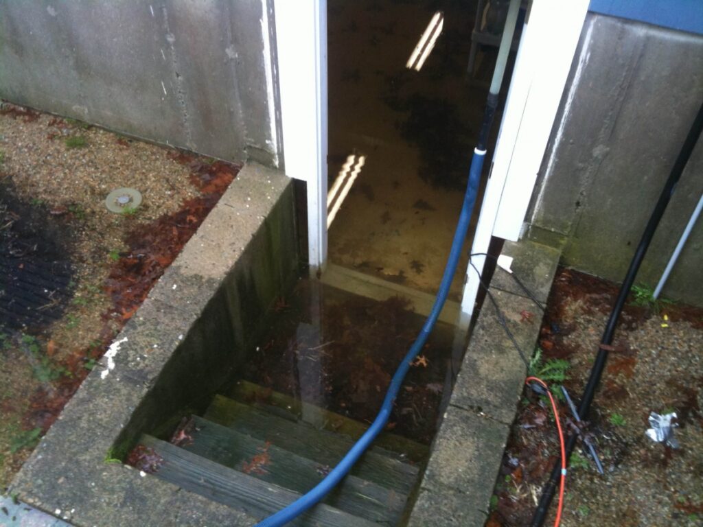 water damage in basement as seen from cement staircase