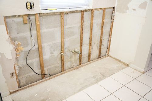 Interior of kitchen with drywall torn out because of water damage